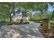 Long driveway leading to a traditional home, surrounded by mature trees and lush greenery at 7861 Live Oaks Dr, Denver, NC 28037