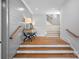 Welcoming entryway featuring wooden floors, a stylish console table, and a staircase leading to upper level at 7861 Live Oaks Dr, Denver, NC 28037