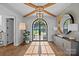 Light-filled foyer with wood floors, designer light fixture, and views of the outdoors at 7861 Live Oaks Dr, Denver, NC 28037