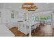 Open kitchen featuring a large marble island, custom white cabinets, and stunning waterfront views at 7861 Live Oaks Dr, Denver, NC 28037