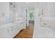 Bright kitchen featuring marble countertops, a farmhouse sink, and custom tile backsplash at 7861 Live Oaks Dr, Denver, NC 28037