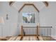 Upper landing with views of mature trees, elegant railing and trim with hardwood floors at 7861 Live Oaks Dr, Denver, NC 28037