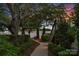 Picturesque pathway leading to the waterfront, surrounded by lush landscaping and mature trees at twilight at 7861 Live Oaks Dr, Denver, NC 28037