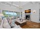 Stunning living room with fireplace, lake views, and stylish decor for comfortable living at 7861 Live Oaks Dr, Denver, NC 28037