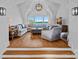 Bright living room featuring hardwood floors, vaulted ceiling, and windows with beautiful lake views at 7861 Live Oaks Dr, Denver, NC 28037