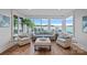 Bright living room featuring large windows, comfortable seating, and stunning views of the water at 7861 Live Oaks Dr, Denver, NC 28037