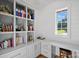 Bright office space with custom built-in shelving, ample storage, and a large window at 7861 Live Oaks Dr, Denver, NC 28037