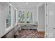 Sunroom featuring a built-in bench, large windows, and views of the surrounding landscape at 7861 Live Oaks Dr, Denver, NC 28037