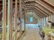Unfinished attic space with exposed beams, open layout, and natural light from a window at 7927 Fairmont Dr, Waxhaw, NC 28173