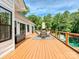 Spacious back deck with outdoor dining, clear railing, and a picturesque view of the backyard pond at 7927 Fairmont Dr, Waxhaw, NC 28173