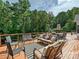 Enjoy relaxing and entertaining on the expansive back deck with stylish furniture and wooded views at 7927 Fairmont Dr, Waxhaw, NC 28173