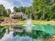 Lovely two-story home with a pond, fountain, a deck, and a beautiful wooded backdrop at 7927 Fairmont Dr, Waxhaw, NC 28173