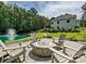 Charming backyard with a cozy fire pit area, seating, and a tranquil pond with a fountain at 7927 Fairmont Dr, Waxhaw, NC 28173