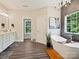 Luxurious bathroom featuring a soaking tub, modern chandelier, and white vanity with marble countertop at 7927 Fairmont Dr, Waxhaw, NC 28173