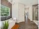 Elegant bathroom showcasing a soaking tub, contemporary chandelier, and large window at 7927 Fairmont Dr, Waxhaw, NC 28173
