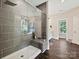 Modern bathroom with a glass-enclosed shower, sleek tiling, and a built-in bench at 7927 Fairmont Dr, Waxhaw, NC 28173