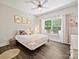 Charming bedroom designed with a white iron bed, floral decorations, and window at 7927 Fairmont Dr, Waxhaw, NC 28173