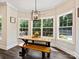 Dining area features a modern table with bench seating and lots of natural light from large windows at 7927 Fairmont Dr, Waxhaw, NC 28173