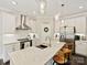 View of kitchen with stainless appliances, granite countertops, white cabinets, and modern pendant lighting at 7927 Fairmont Dr, Waxhaw, NC 28173