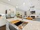 Modern kitchen with stainless steel appliances, white cabinets, and a view into the living room at 7927 Fairmont Dr, Waxhaw, NC 28173
