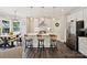 Bright, white kitchen features stainless steel appliances, a central island with bar seating, and modern pendant lighting at 7927 Fairmont Dr, Waxhaw, NC 28173