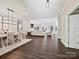 Open-concept living space with hardwood floors, neutral decor, and seamless flow into the dining area at 7927 Fairmont Dr, Waxhaw, NC 28173
