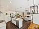 Open floorplan features a kitchen with island, stainless steel appliances, and view into living room and dining area at 7927 Fairmont Dr, Waxhaw, NC 28173