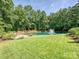 Picturesque pond with a fountain, surrounded by lush greenery and a well-maintained lawn at 7927 Fairmont Dr, Waxhaw, NC 28173