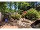 Lush backyard garden with a charming pond and mature landscaping at 85 Riley Dr, Taylorsville, NC 28681