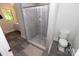 Bathroom features a gray tiled shower, toilet, and dark flooring at 85 Riley Dr, Taylorsville, NC 28681