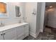 Bathroom with double sink vanity, mirror, and gray flooring at 85 Riley Dr, Taylorsville, NC 28681