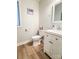Cozy half-bath featuring a wood-look floor, a white vanity, and neutral walls at 85 Riley Dr, Taylorsville, NC 28681