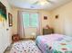 Bright bedroom with a colorful rug, playful decor, and window views at 85 Riley Dr, Taylorsville, NC 28681