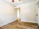 Clean bedroom featuring light wood floors, white walls, and natural light from the window at 85 Riley Dr, Taylorsville, NC 28681