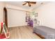 Bright bedroom with wood look floors, ceiling fan and natural light from a window at 85 Riley Dr, Taylorsville, NC 28681