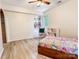 Cozy bedroom featuring a colorful bedspread, built-in shelving, and natural light from a window at 85 Riley Dr, Taylorsville, NC 28681