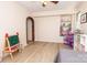 Bright bedroom with wood look floors and natural light from a window and an arched doorway at 85 Riley Dr, Taylorsville, NC 28681
