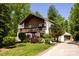 Charming two-story home with a wood deck, detached garage, and well-maintained landscaped yard at 85 Riley Dr, Taylorsville, NC 28681