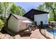 Rear exterior featuring a deck, fenced pool, and mature trees at 85 Riley Dr, Taylorsville, NC 28681