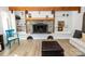 Stone fireplace and hearth with built in bookshelves and wooden beam accent at 85 Riley Dr, Taylorsville, NC 28681