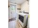 Bright laundry room with modern washer and dryer, plus exterior door and colorful rug at 85 Riley Dr, Taylorsville, NC 28681