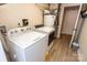 Functional laundry room with a white washer, dryer, and hot water heater at 85 Riley Dr, Taylorsville, NC 28681