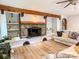 Inviting living room showcasing a stone fireplace, wood beams, built-in shelves, and hardwood flooring at 85 Riley Dr, Taylorsville, NC 28681
