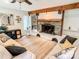 Bright living room featuring a stone fireplace, wood beam accents, built-in shelving, and light wood floors at 85 Riley Dr, Taylorsville, NC 28681