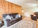Inviting living room featuring wood paneling, plush seating, and stylish decor at 85 Riley Dr, Taylorsville, NC 28681