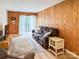 Relaxing living room with wood walls, large sofa, and access to the outdoors at 85 Riley Dr, Taylorsville, NC 28681