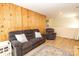 Comfortable living room with a comfortable couch, wood paneling, and neutral tones at 85 Riley Dr, Taylorsville, NC 28681