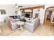 Bright living room with wood-beamed ceilings, stone fireplace, and hardwood floors at 85 Riley Dr, Taylorsville, NC 28681