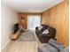 Cozy living room with a comfortable couch, wood paneling, and access to the outdoors at 85 Riley Dr, Taylorsville, NC 28681