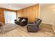 Comfortable living room with a comfortable couch, wood paneling, and neutral tones at 85 Riley Dr, Taylorsville, NC 28681